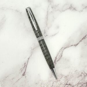 Black Curly Maple Everyday Twist Pen on a Marble Tabletop