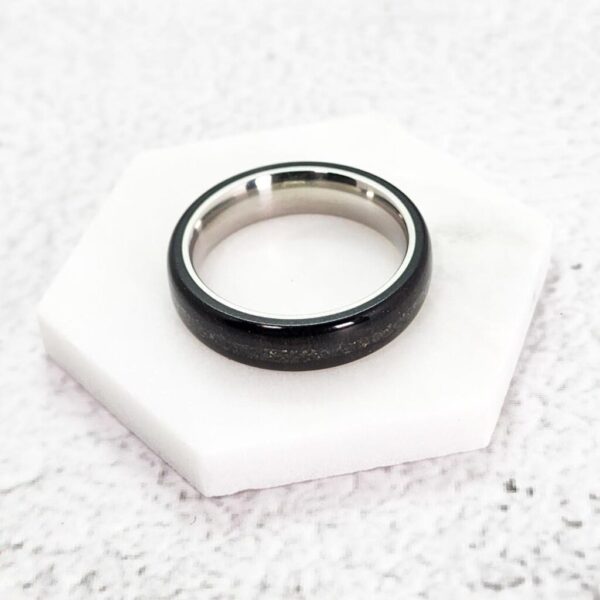 African Blackwood Stainless Steel ring with a Pyrite Inlay on a piece of marble